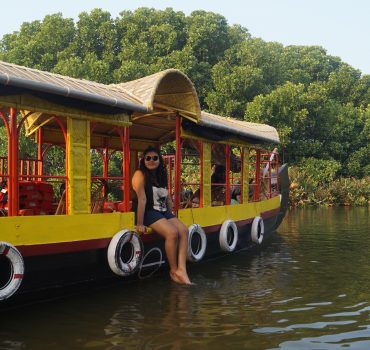 Woman sitting in boat on Ashtamudi lake